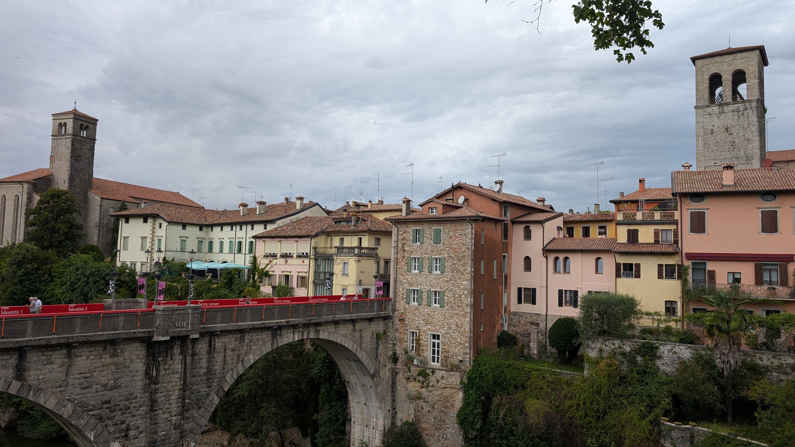 Stone Devil’s Bridge spanning the Natisone gorge toward Cividale’s pastel houses and twin bell towers