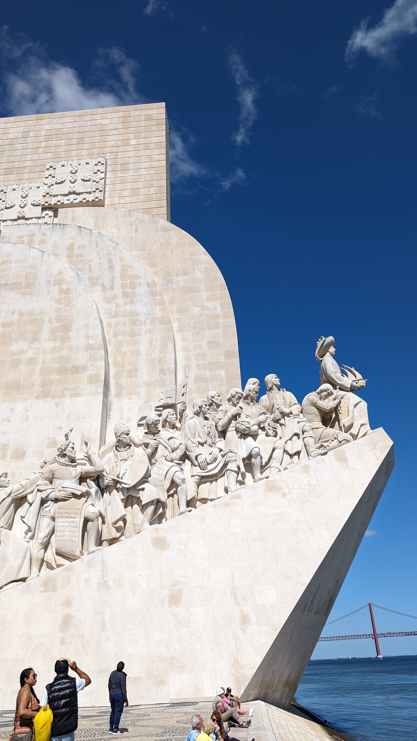 Limestone prow of the Monument to the Discoveries with Henry the Navigator at the front, the Tagus and the 25 de Abril Bridge behind