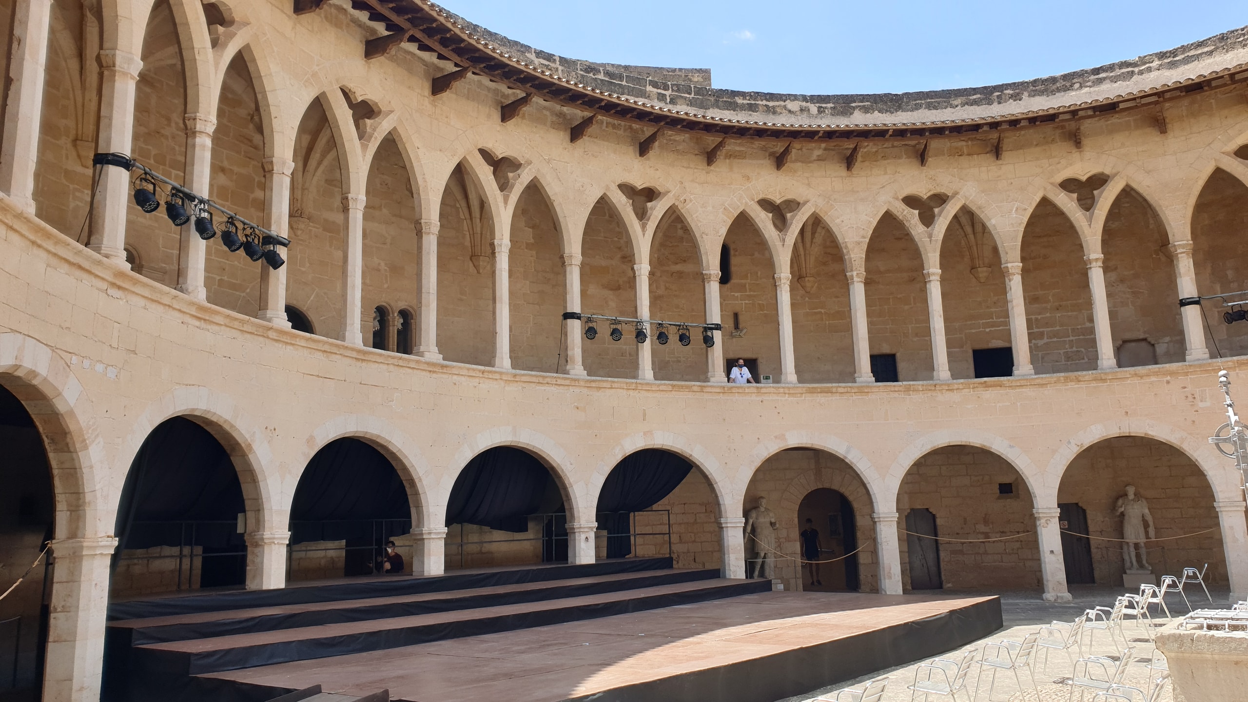 The circular two-storey Gothic courtyard inside Palma's Bellver Castle under a clear blue sky