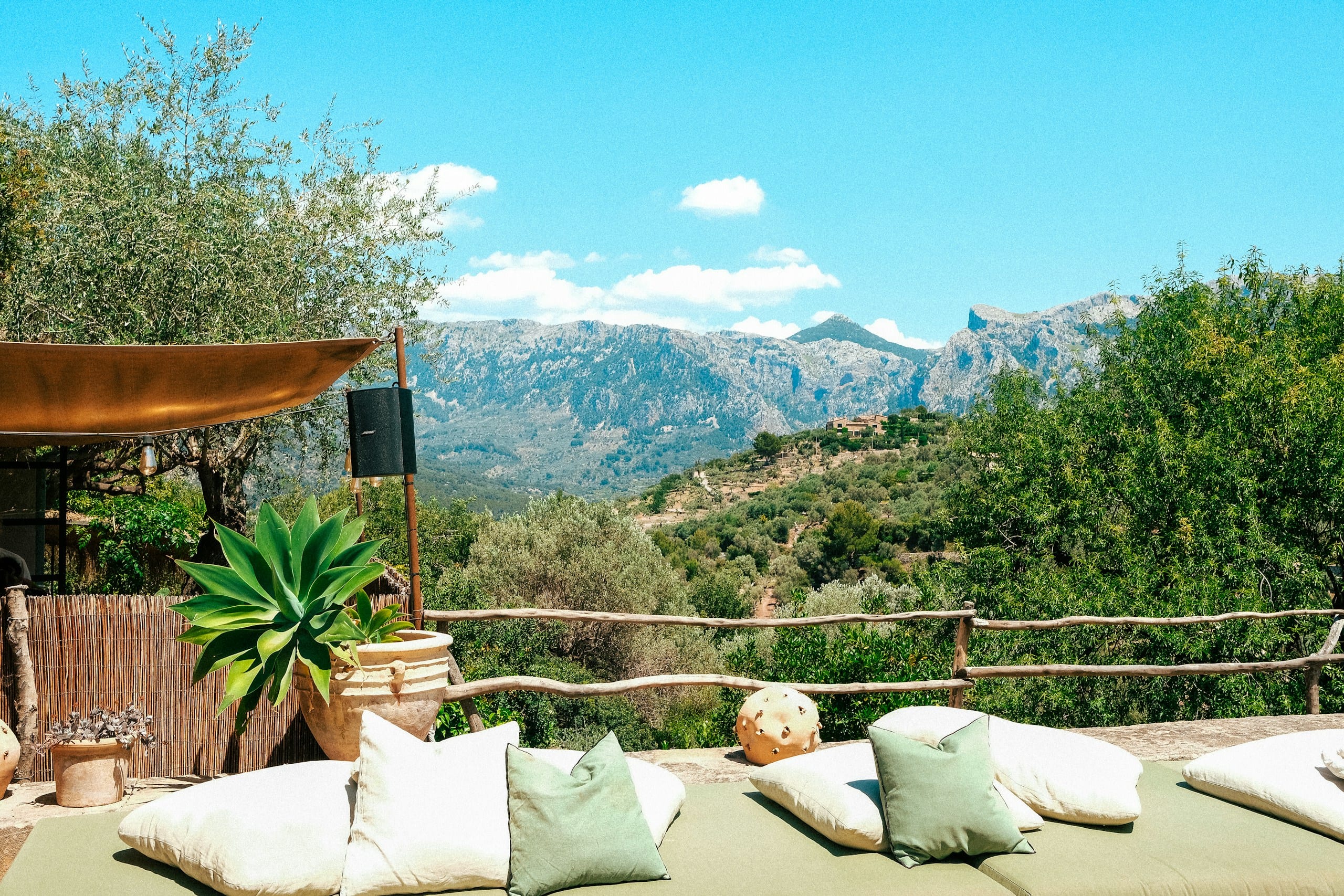 Terraced hills and forested Tramuntana mountains rising above a stone terrace near Sóller and Deià in northwest Mallorca