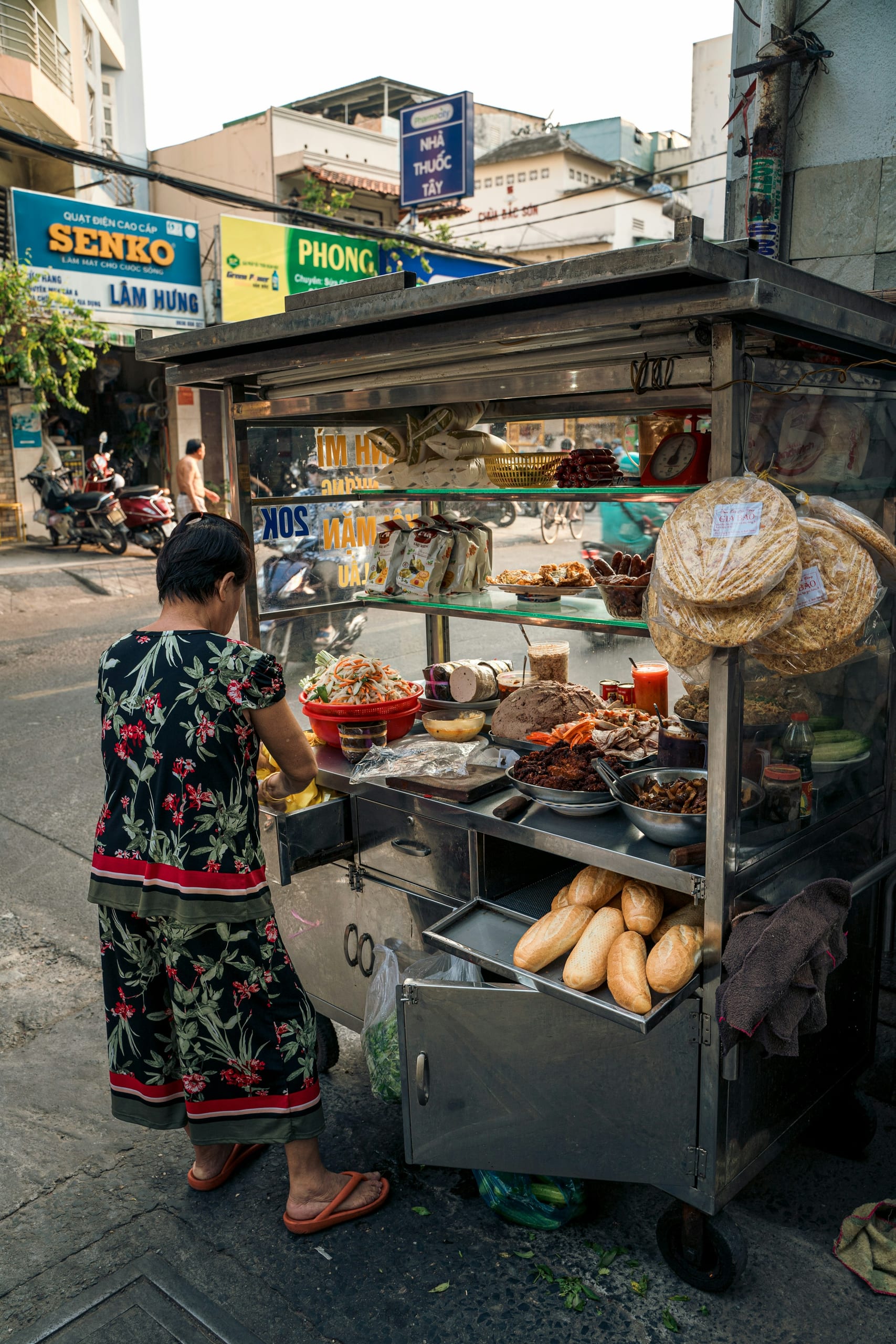 A bánh mì vendor at her street cart in Ho Chi Minh City's District 3